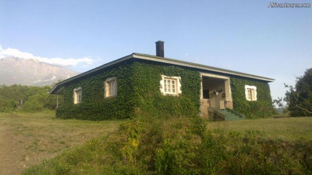 Tanapa (arusha) rest house of Arusha national park,  view from the front with mt. Meru on the far left